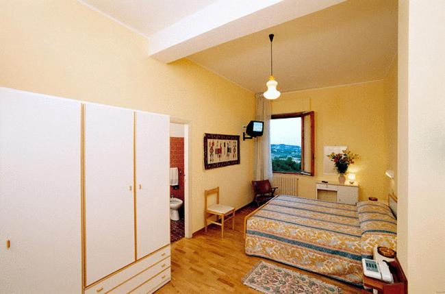 Postel nebo postele na pokoji v ubytování Hotel Risorgimento