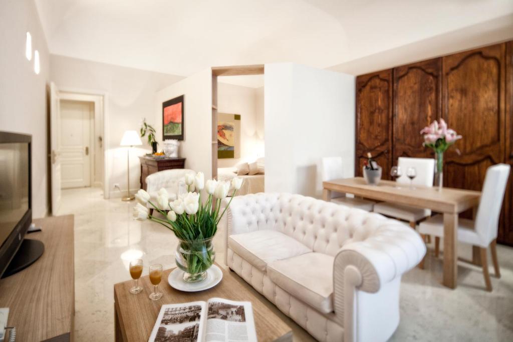 a living room with a white couch and a table at Hotel Palazzo Brunaccini in Palermo