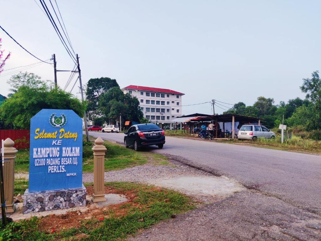 un panneau indiquant un hôtel sur le côté d'une route dans l'établissement Padang Besar Guesthouse Firdaus, à Padang Besar