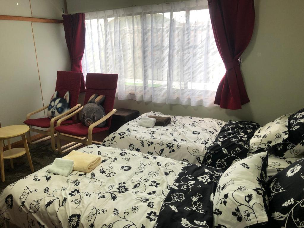 Postel nebo postele na pokoji v ubytování Guesthouse Yui