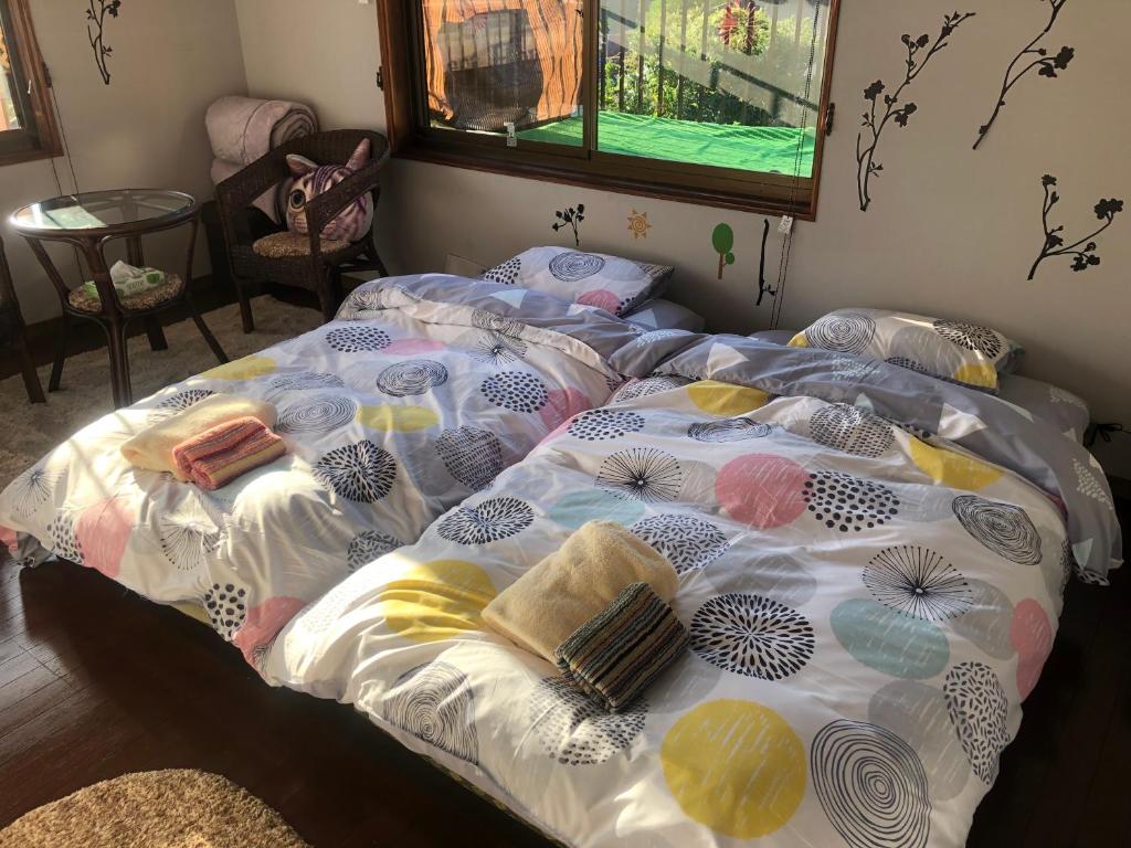 Postel nebo postele na pokoji v ubytování Guesthouse Yui