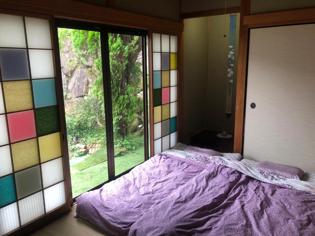 Postel nebo postele na pokoji v ubytování Guesthouse Yui