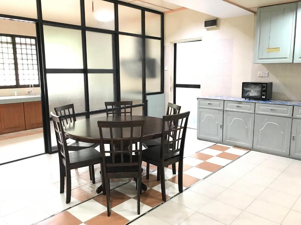 a kitchen with a dining room table and chairs at Shangrila House @ 香格里拉民宿 in Tawau