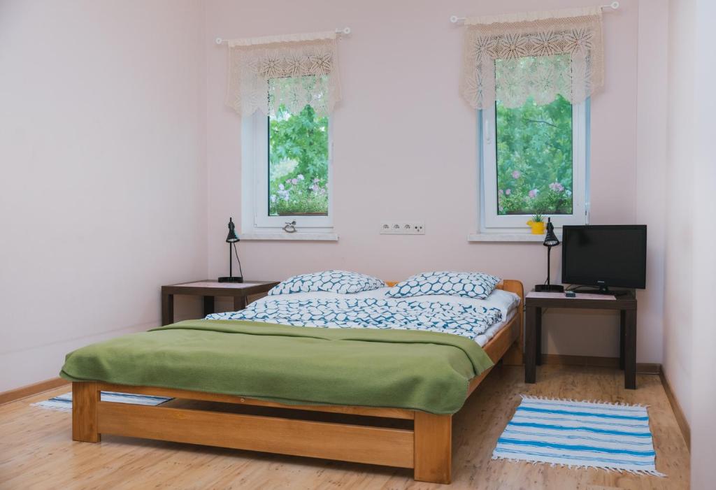 Postel nebo postele na pokoji v ubytování Agroturystyka Pod Modrzewiami