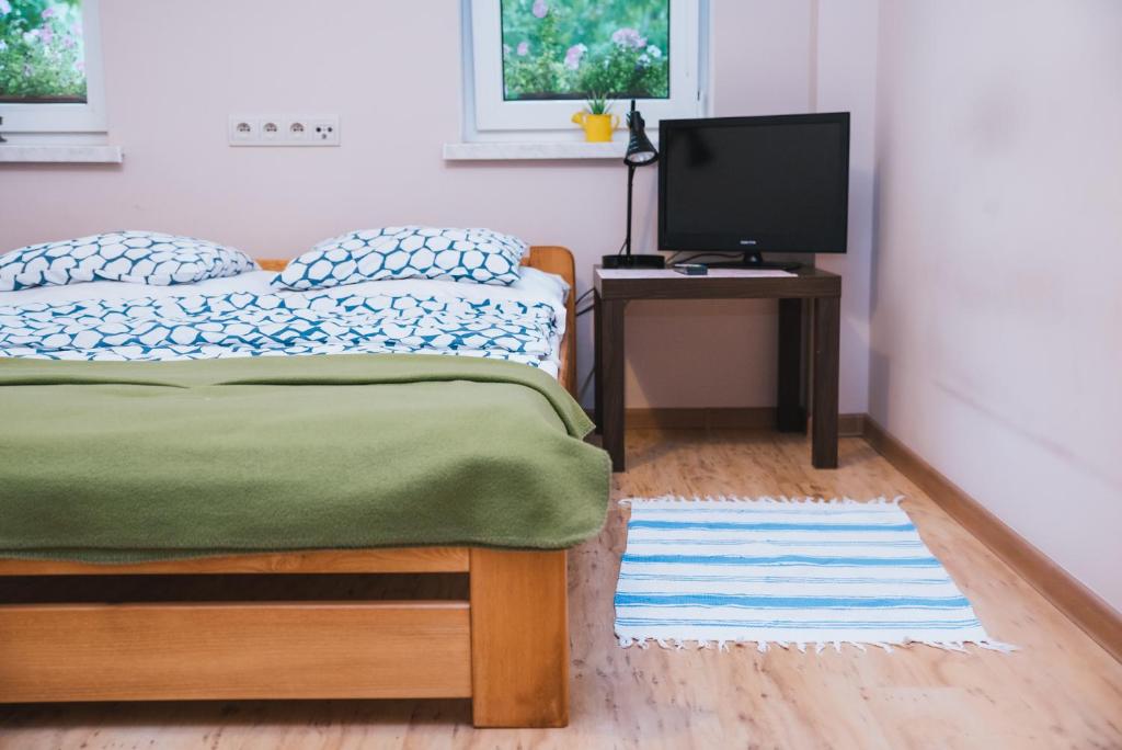 Postel nebo postele na pokoji v ubytování Agroturystyka Pod Modrzewiami