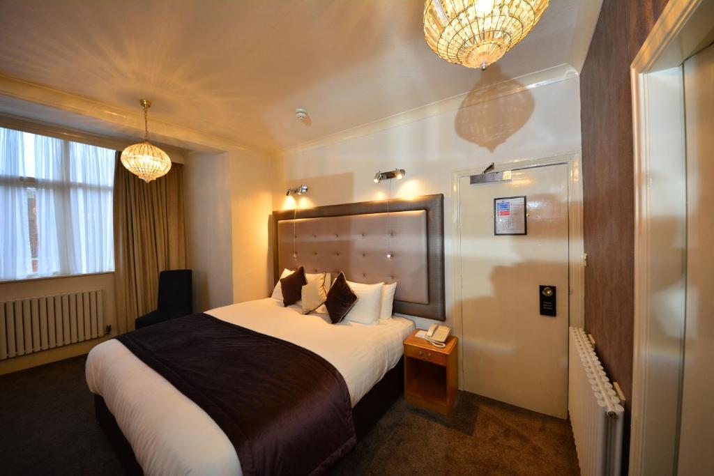 a hotel room with a bed and a telephone at The Crescent Hotel in Scarborough