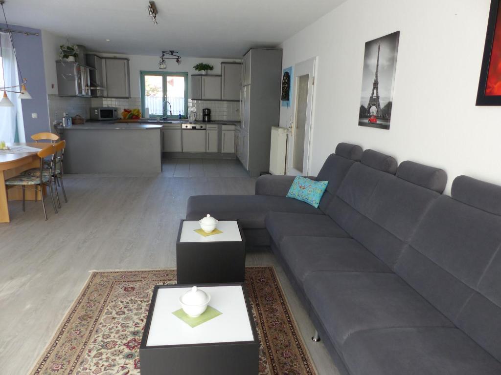 a living room with a couch and a kitchen at Haus Isabella in Boltenhagen