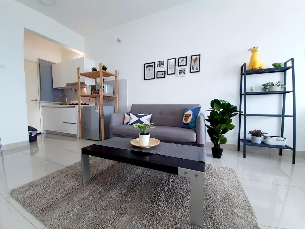 a living room with a couch and a table at Galleria Equine Park @ Seri Kembangan in Seri Kembangan