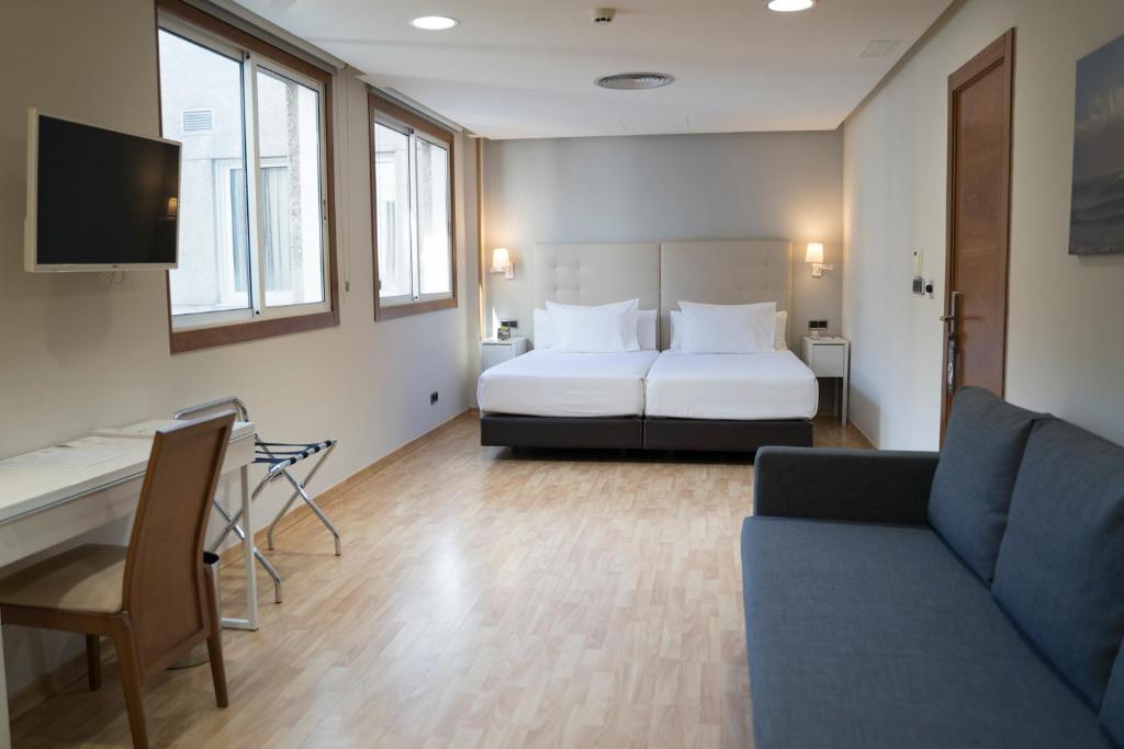 Posteľ alebo postele v izbe v ubytovaní Hotel Sercotel Tres Luces