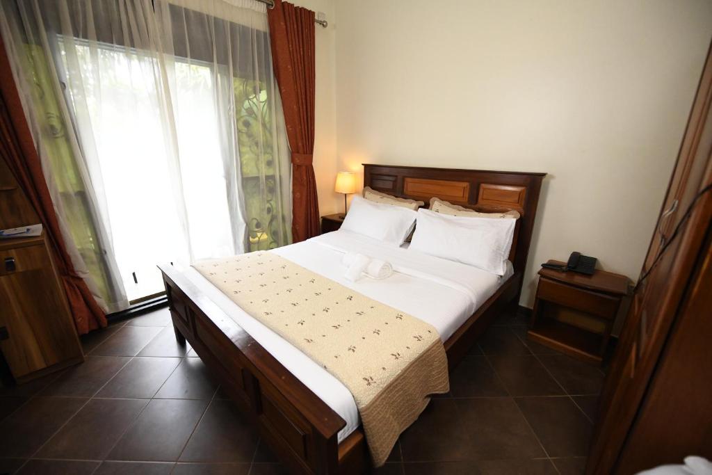 Postel nebo postele na pokoji v ubytování Biyem Hotel
