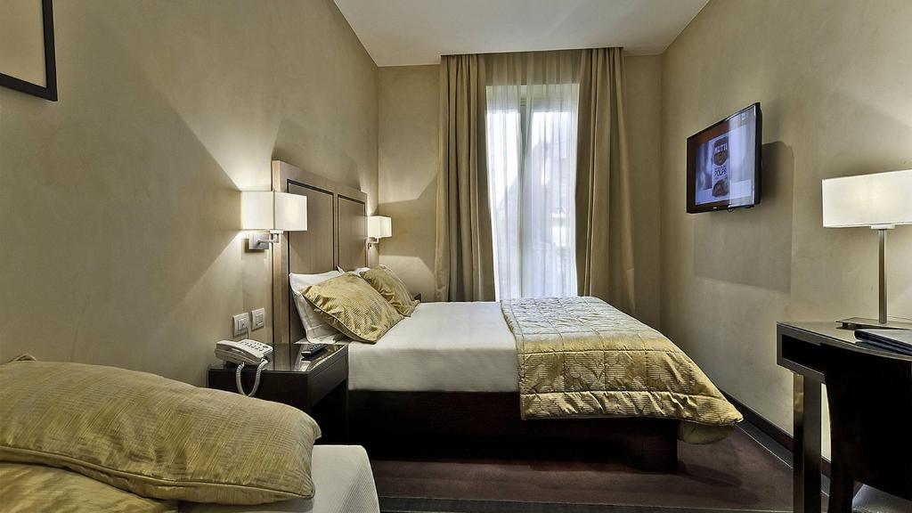 a hotel room with a bed and a window at Intown Luxury House in Rome