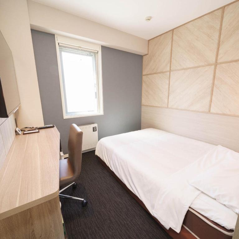 Postel nebo postele na pokoji v ubytování Super Hotel Hida Takayama