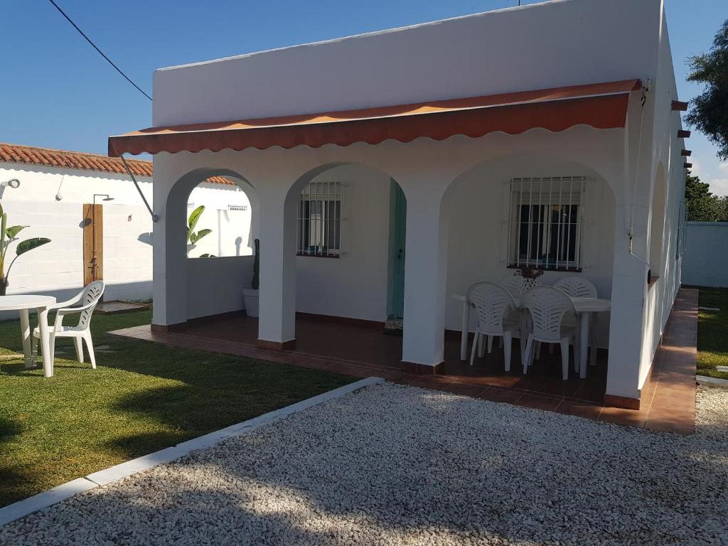 a patio with a table and chairs in a yard at Casa Angy 3 in Zahora