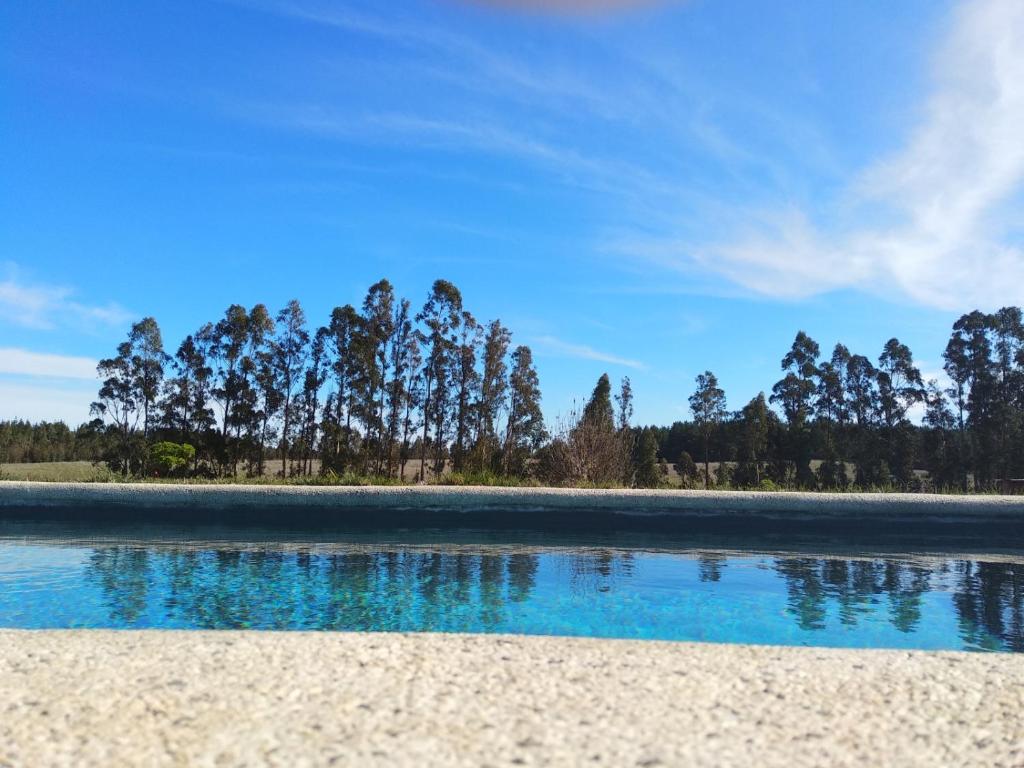 a body of water with trees in the background at Casa Familiar Reserva Humedal in El Convento