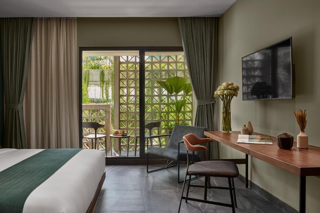 Postel nebo postele na pokoji v ubytování Baitong Hotel & Resort Phnom Penh
