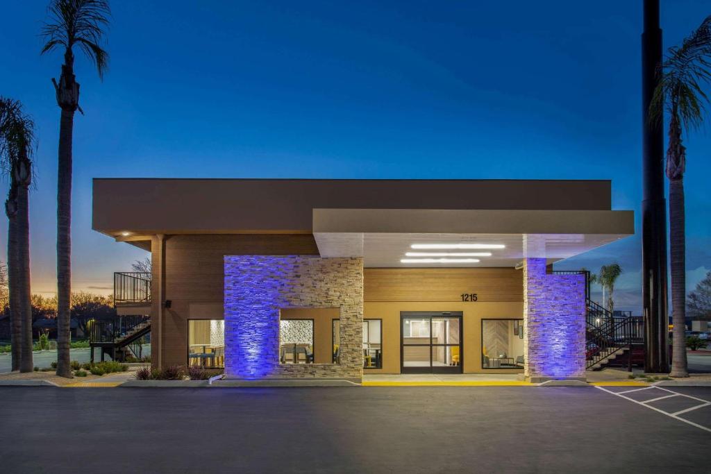 a building with blue lights in a parking lot at Days Inn Merced / Yosemite Area in Merced