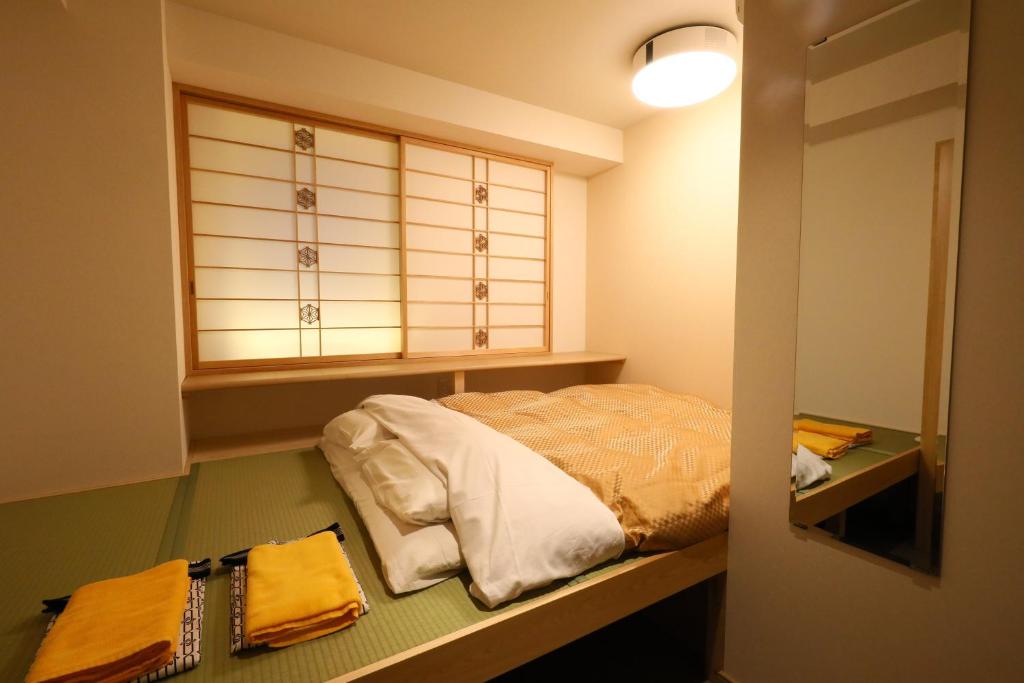 Postel nebo postele na pokoji v ubytování Wa Style Tokyo