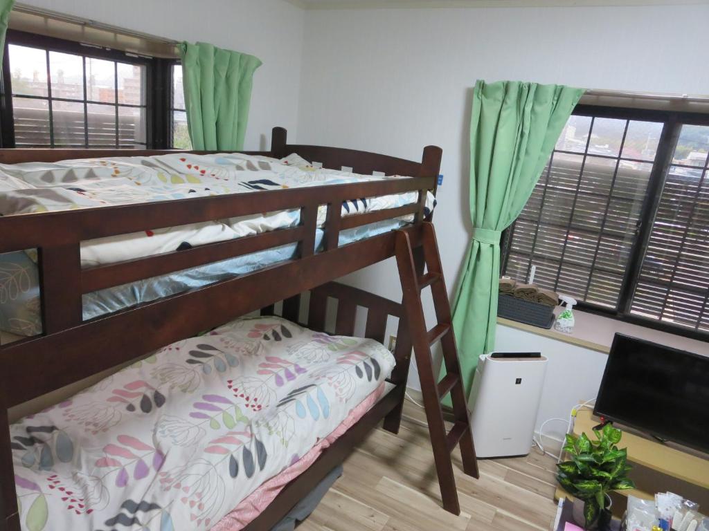 熊本的住宿－Comfort CUBE PHOENIX S Kumamoto，一间卧室设有两张双层床和一扇窗户。