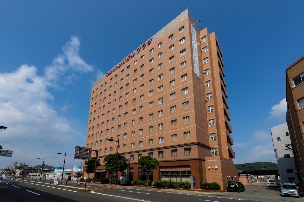 un edificio alto marrón en una calle de la ciudad en Shimonoseki Station West Washington Hotel Plaza, en Shimonoseki