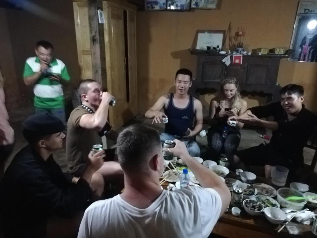 a group of people sitting around a table eating at Dồn Dao Homestay in Ha Giang