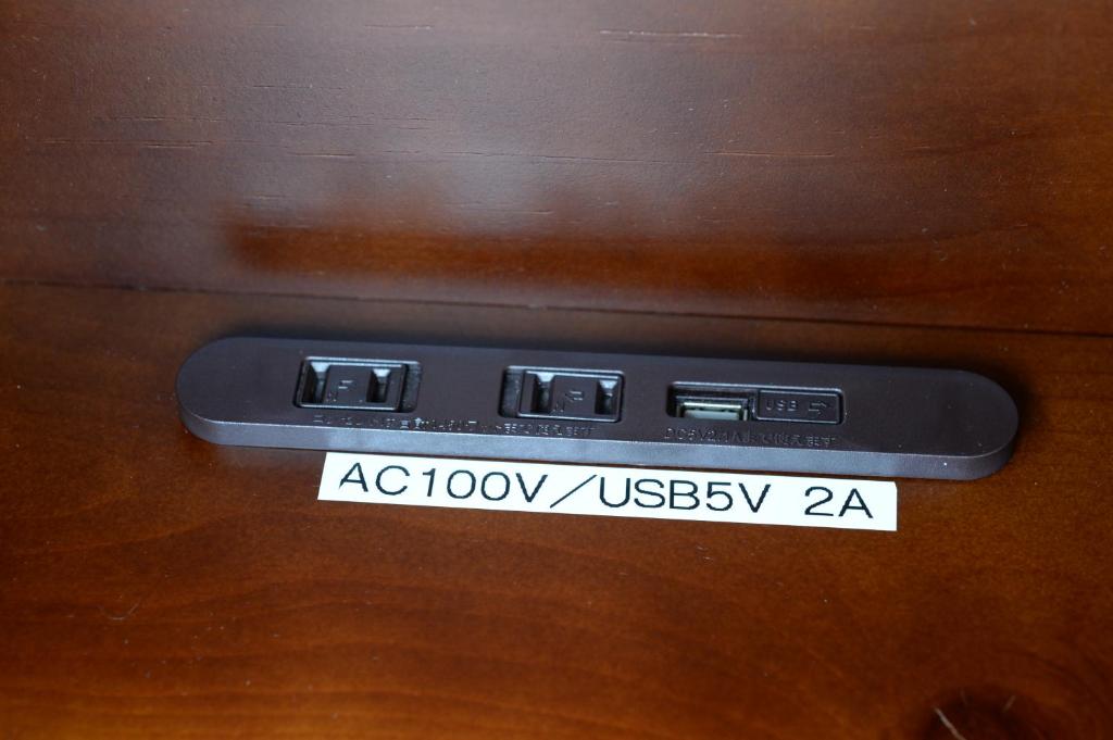 a remote control on top of a wooden table at Guesthouse Iwase in Toyama