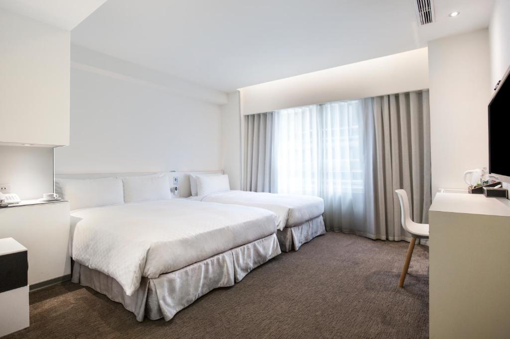 Postel nebo postele na pokoji v ubytování CityInn Hotel Taipei Station Branch II