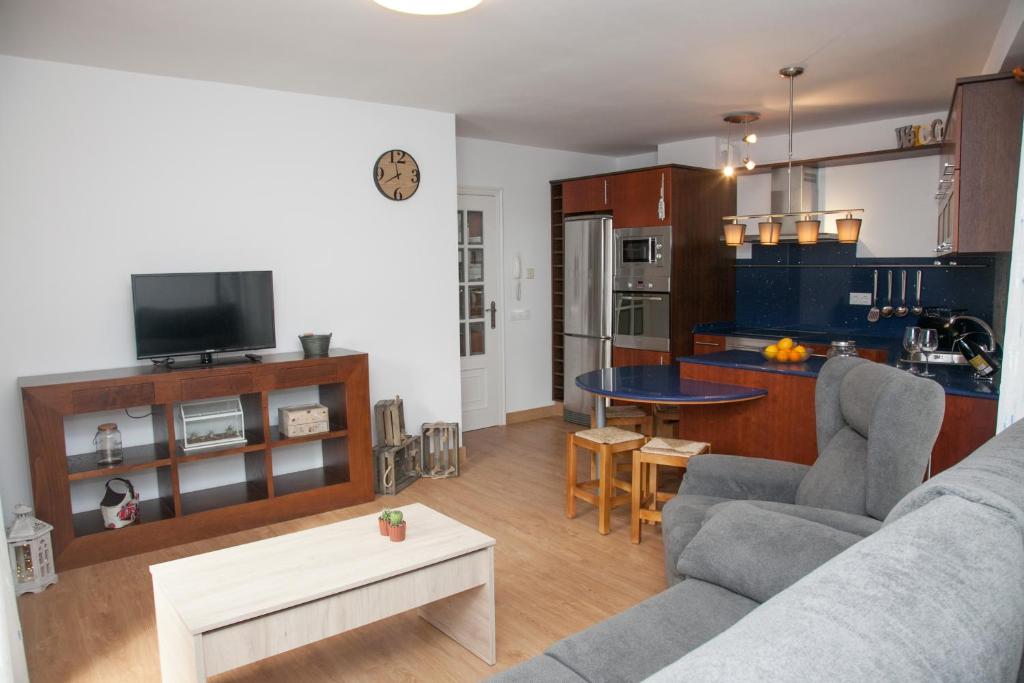 ein Wohnzimmer mit einem Sofa und einem Tisch in der Unterkunft Piso das Costureiras in Pontevedra