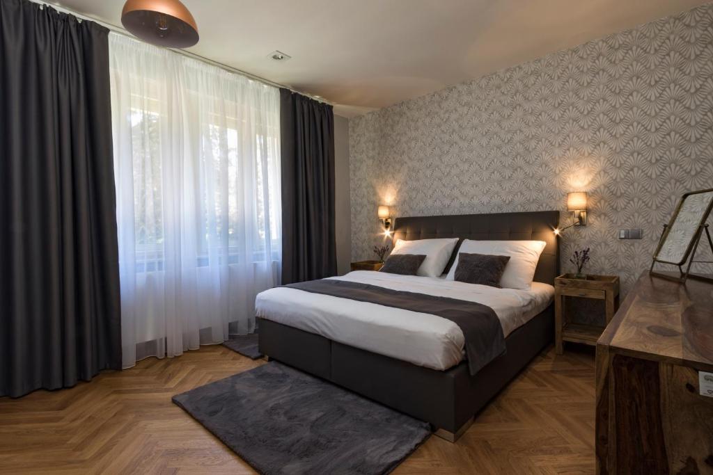 Uma cama ou camas num quarto em Areal Botanika