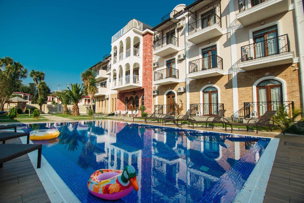 a swimming pool in front of a building at Bude in Gonio