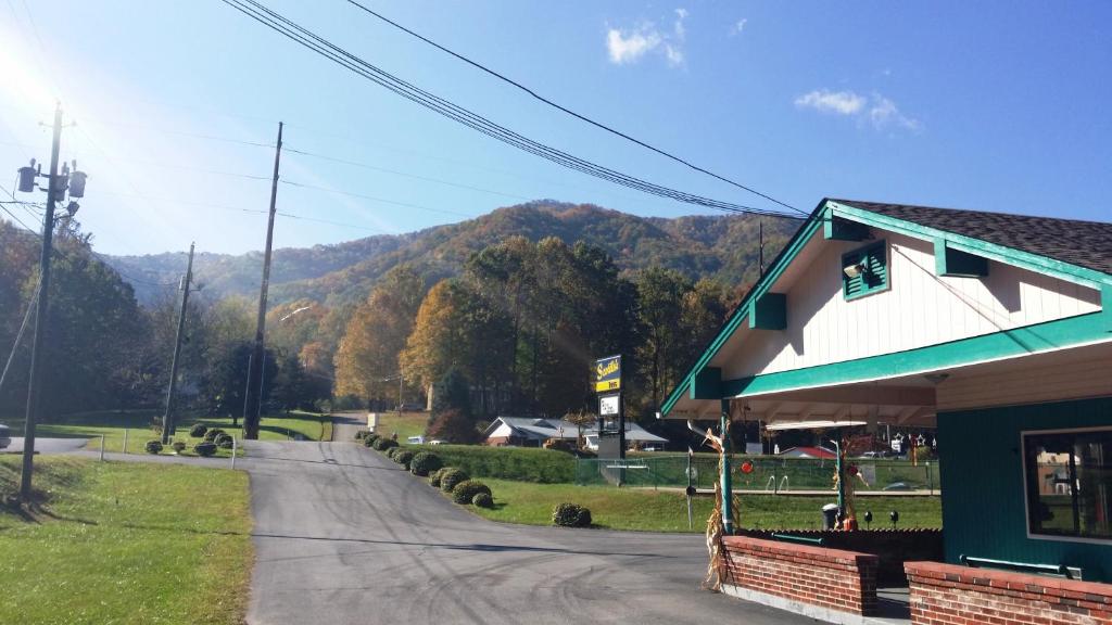 a building on a street next to a mountain at Scottish Inn Maggie Valley in Maggie Valley