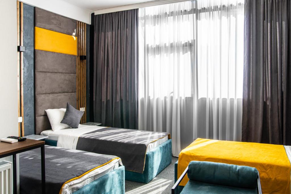 Postel nebo postele na pokoji v ubytování BG Palace Hotel