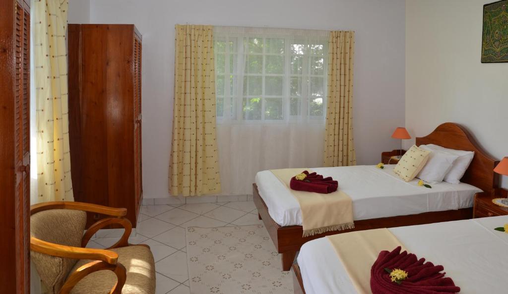 Postel nebo postele na pokoji v ubytování Ixora Villa