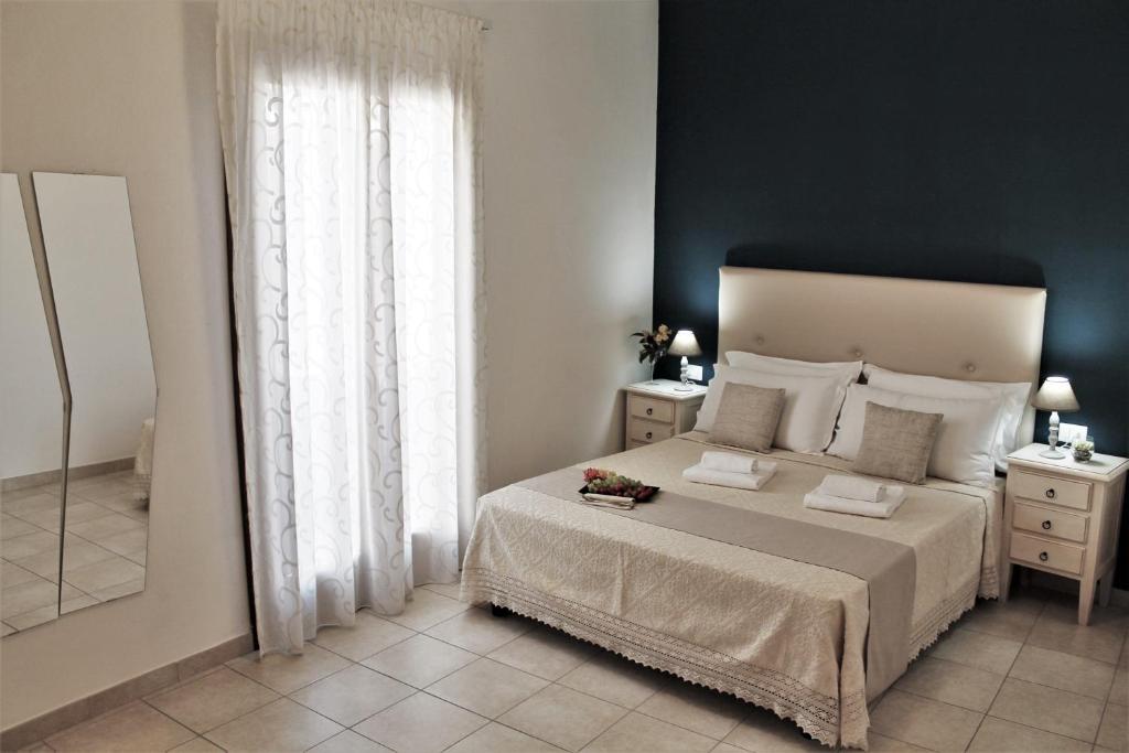 Postel nebo postele na pokoji v ubytování AHR Leonis Residence La Maddalena