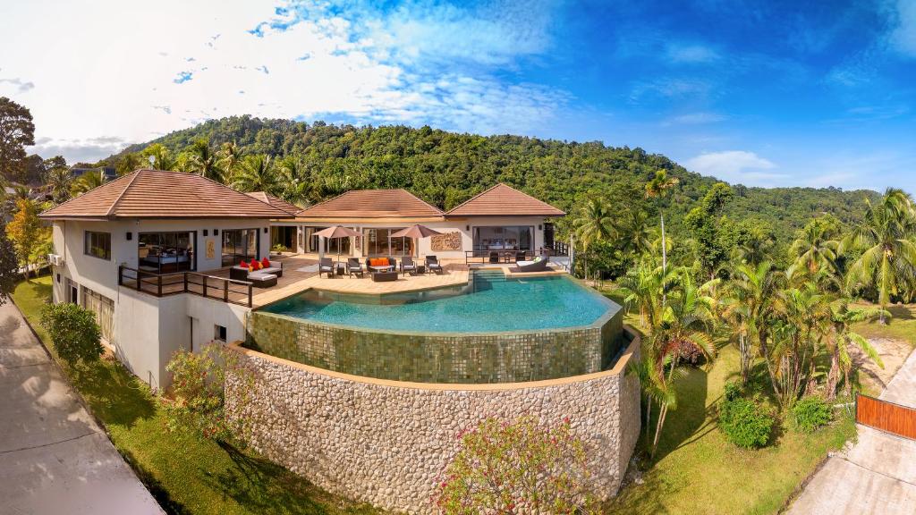 an aerial view of a house with a swimming pool at 5 Bedroom Sea View Villa Bubbles SDV376 By Samui Dream Villas in Mae Nam