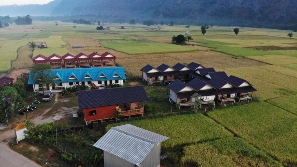 an aerial view of a village in a field at Thongdam Guesthouse in Ban O