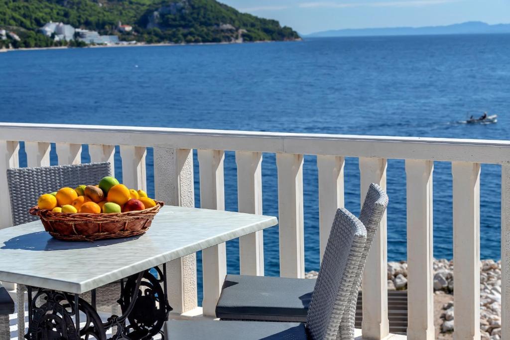 a basket of fruit sitting on a table on a balcony at Dado A6 Apartments in Igrane