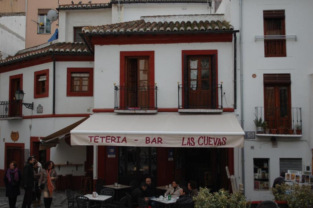 a restaurant with a sign in front of a building at Centro de Granada in Granada