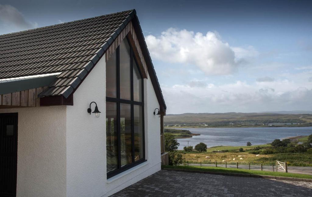 a house with a view of a body of water at Creag Moine Luxury Self Catering in Kensaleyre