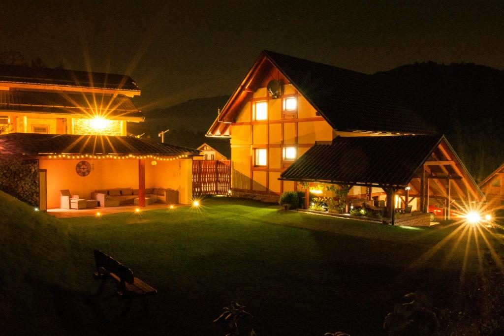 a large house with a large yard at night at Chata Valca PATJA in Valča