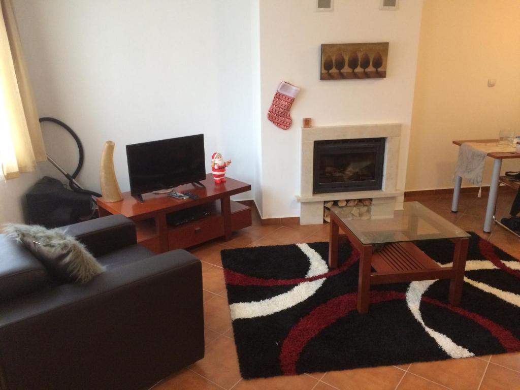 a living room with a couch and a fireplace at Demianitza complex in Bansko