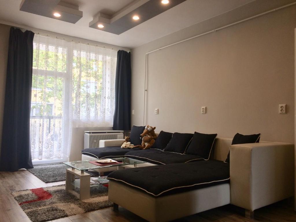 a living room with a couch and a window at Home in Zalaegerszeg