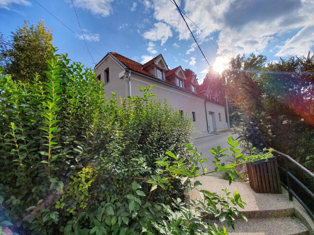 a white building with the sun in the sky at Rooms Korina in Samobor