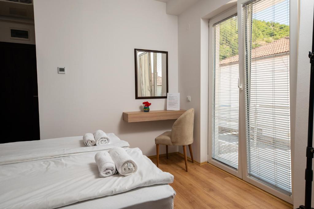 Postel nebo postele na pokoji v ubytování Apartments Bashoski