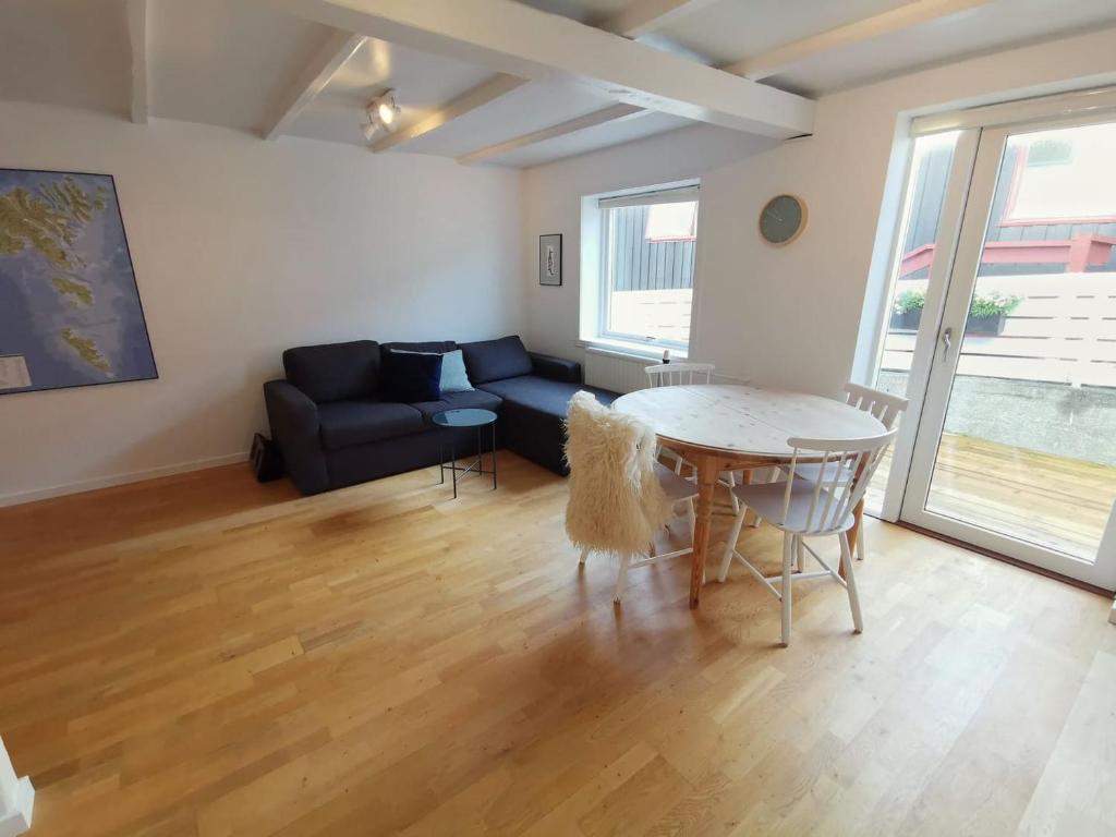 a living room with a table and a couch at City Center Apartment in Tórshavn