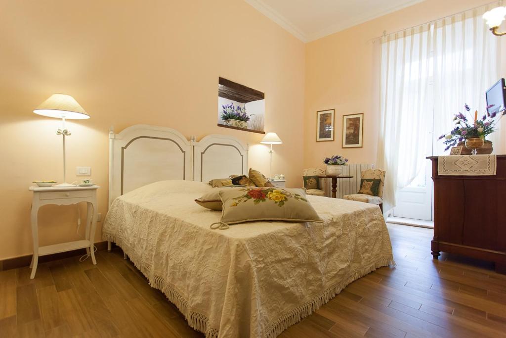 a bedroom with a bed with a white bedspread at Casa Riccardi in Putignano