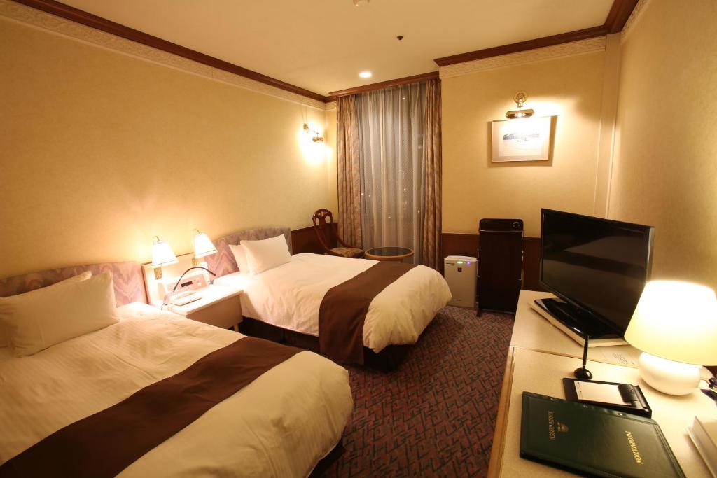 Postel nebo postele na pokoji v ubytování Hotel Sunlife Garden