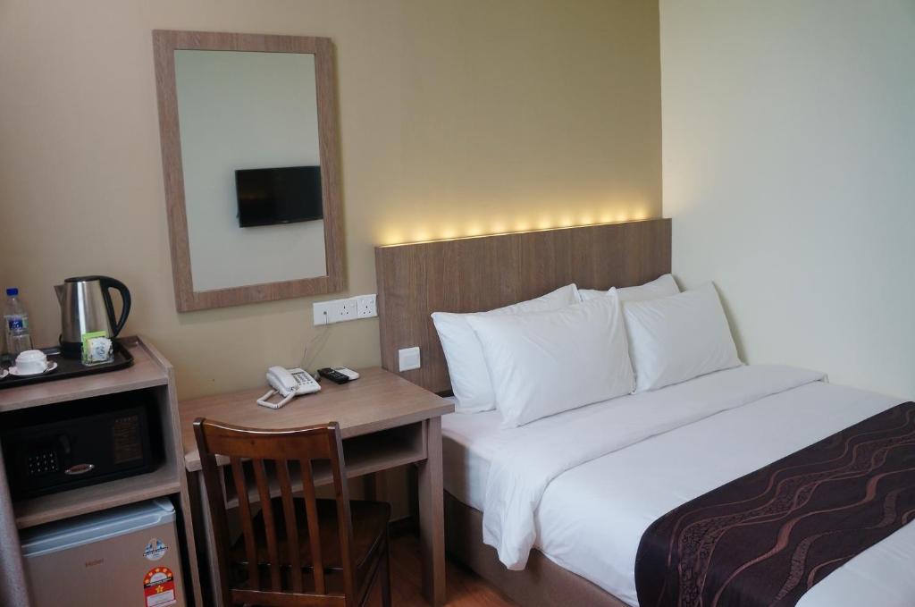 Postel nebo postele na pokoji v ubytování LABUAN JATI HOTEL