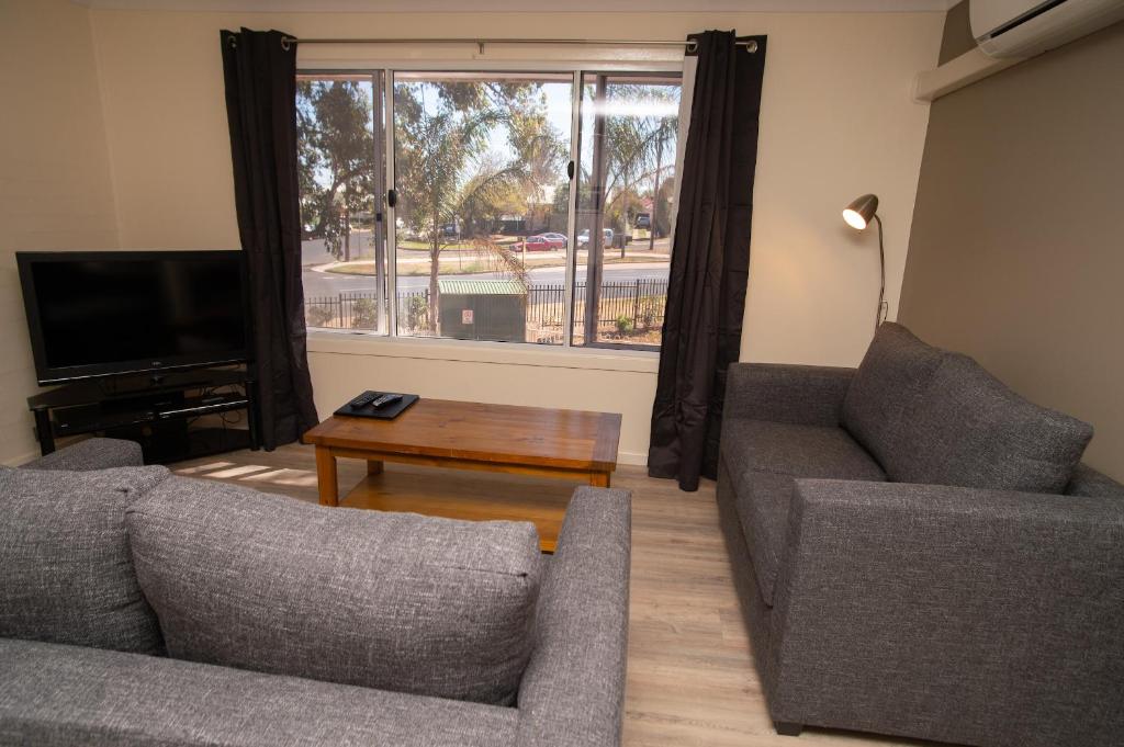 a living room with two couches and a coffee table at Manera Heights Apartments in Dubbo