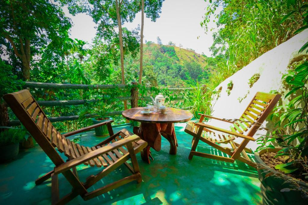 a patio with two chairs and a table and a table and chairs at Happy Horizon Home Stay in Ella