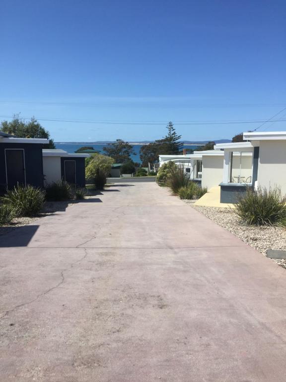 an empty driveway in front of a row of houses at Old Pier Apartments in Bridport